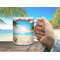Lifestyle image of a person enjoying coffee in a beach setting.